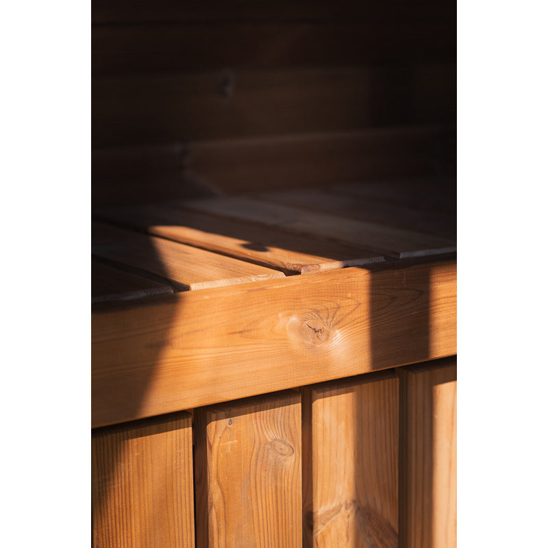 Detail of the seating area in the Ula Micro sauna - natural wood with a warm lighting atmosphere