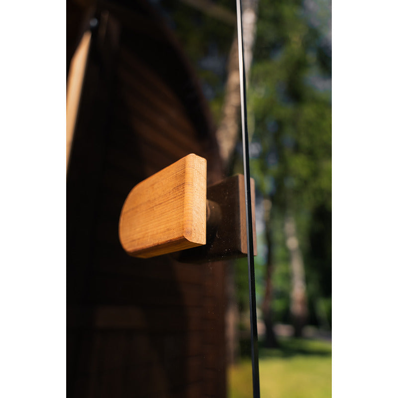 Wooden handle on the glass door of the Celsium Ula Micro sauna - functional detail with an elegant feel